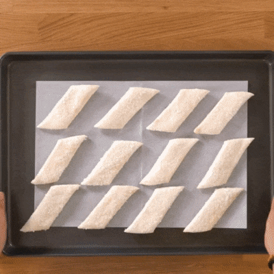 People putting Cheese Rolls in the oven